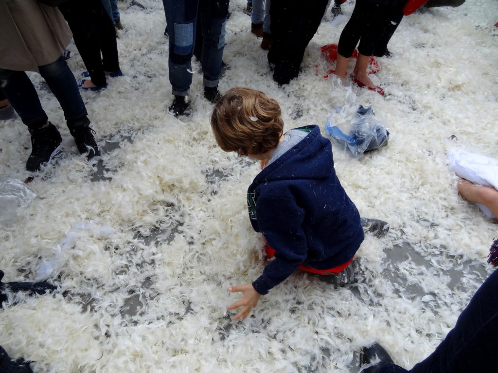 Kid playing with feathers